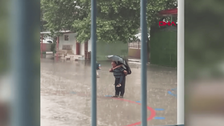 Sağanak altında İstiklal Marşı: Sırtında torunu, elinde şemsiye ile bekledi...